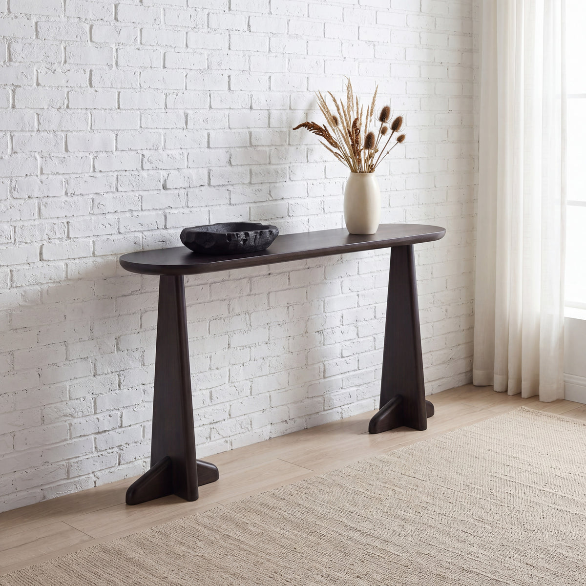 Greenington Zephyr Console Table in Caviar bamboo, shown in a living room