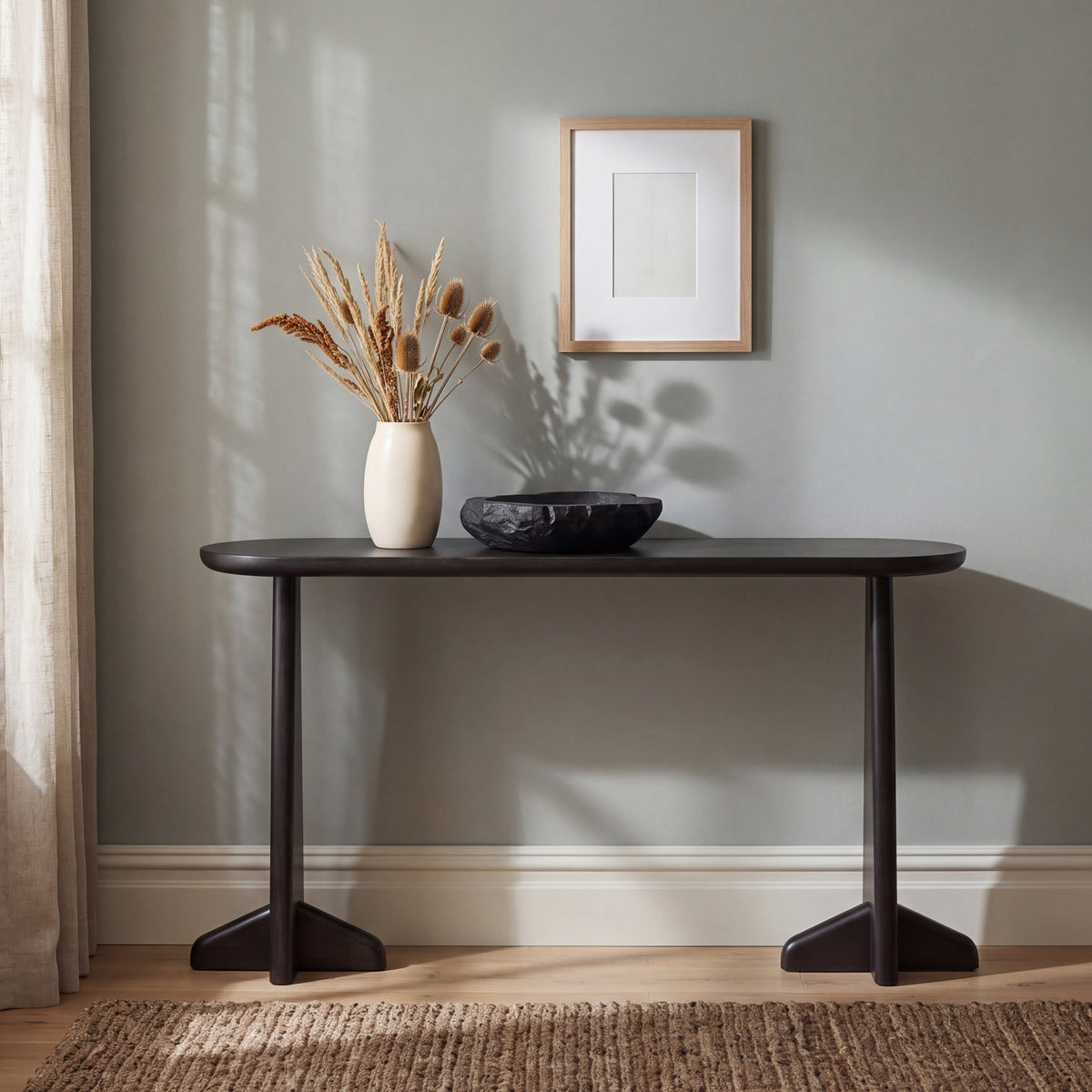 Greenington Zephyr Console Table in Caviar bamboo, styled in a living room