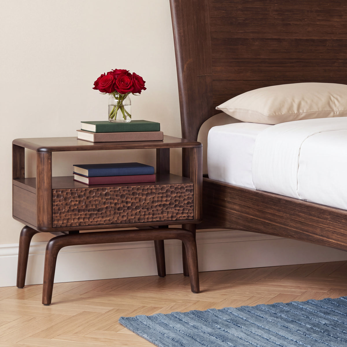 Greenington Zeva Nightstand in Black Walnut bamboo beside a Zeva Platform Bed, styled in a bright bedroom, three-quarter view