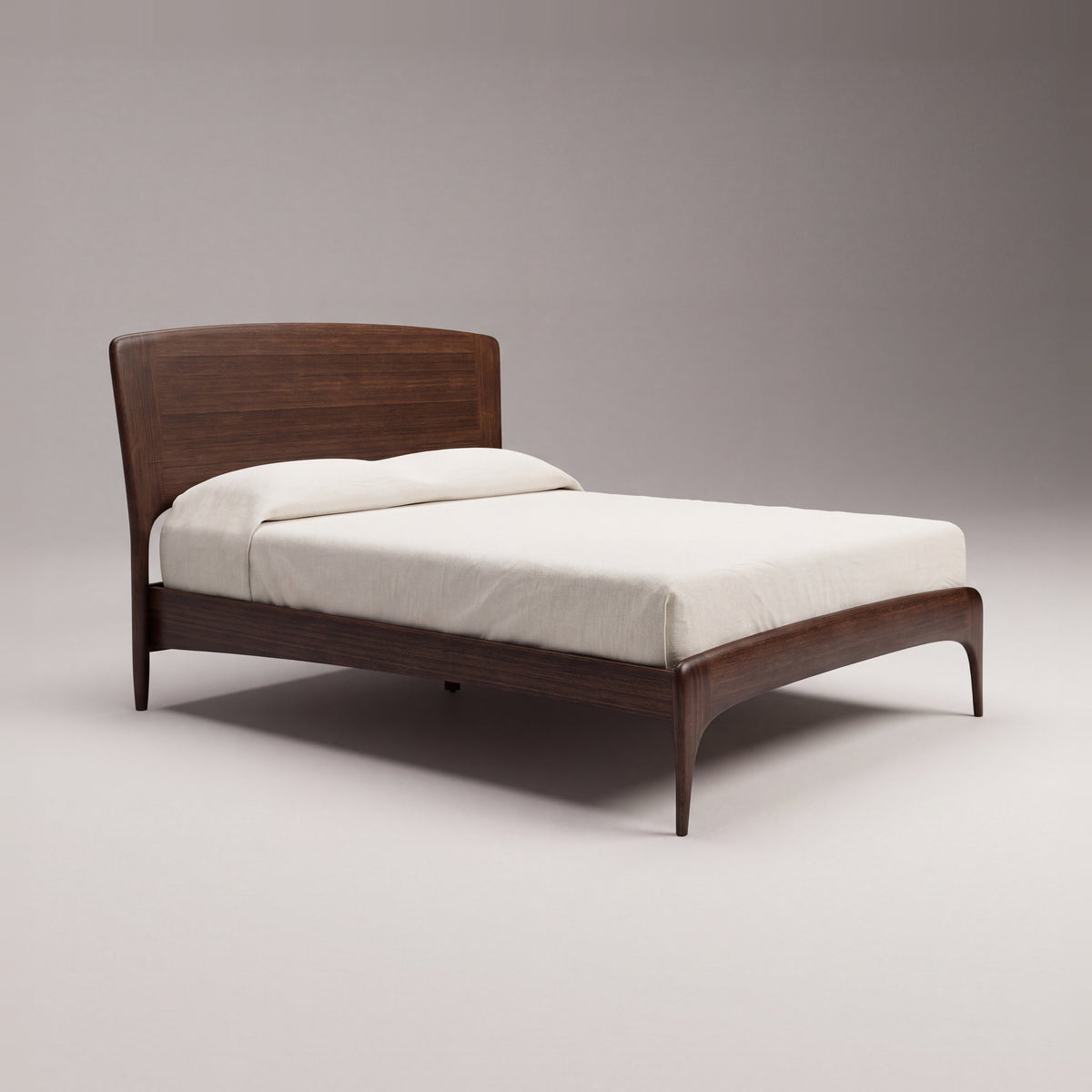 Greenington Zeva Platform Bed in Black Walnut bamboo with ivory linen bedding, on a light studio background, three-quarter view