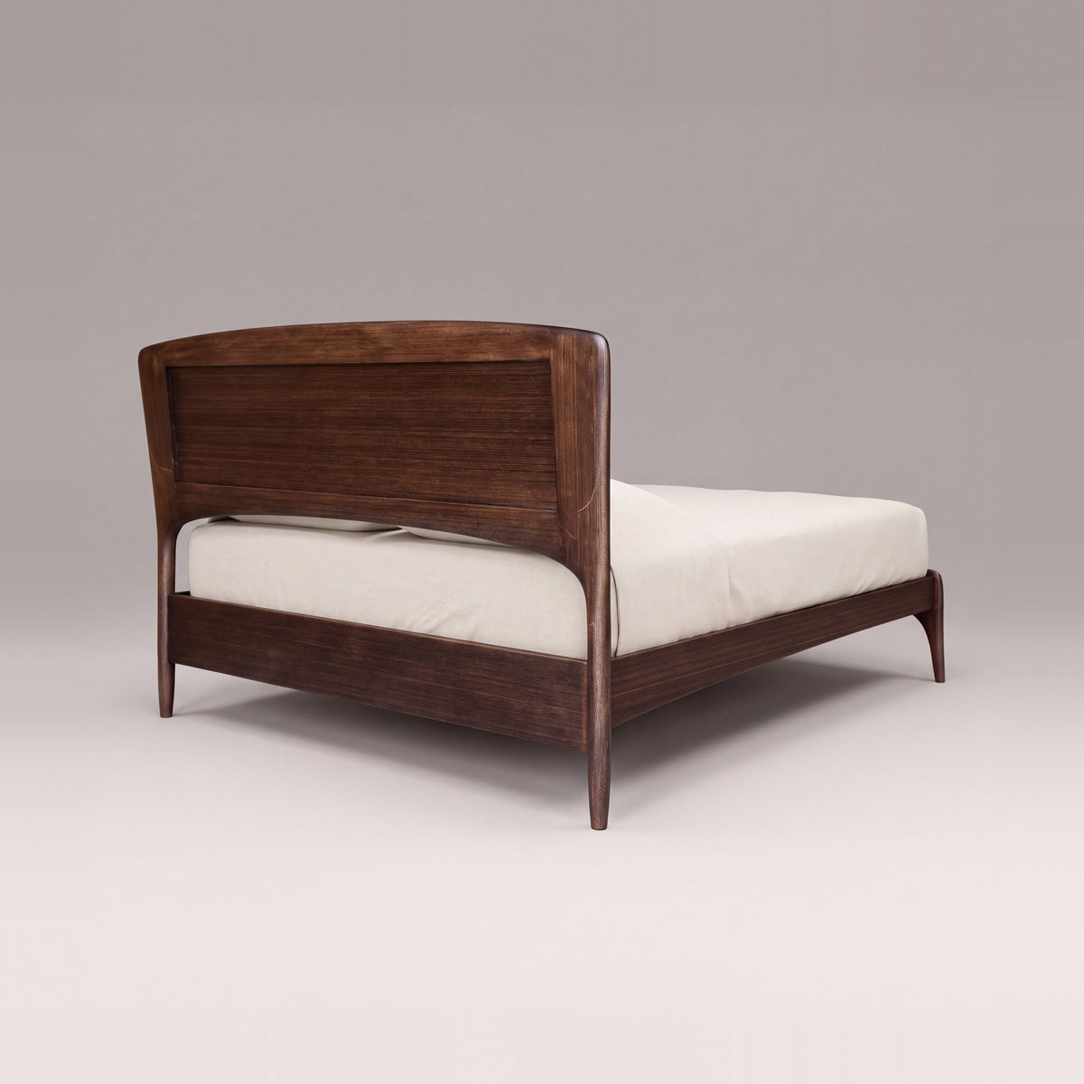 Greenington Zeva Platform Bed in Black Walnut bamboo, on a light studio background, rear three-quarter view of the headboard