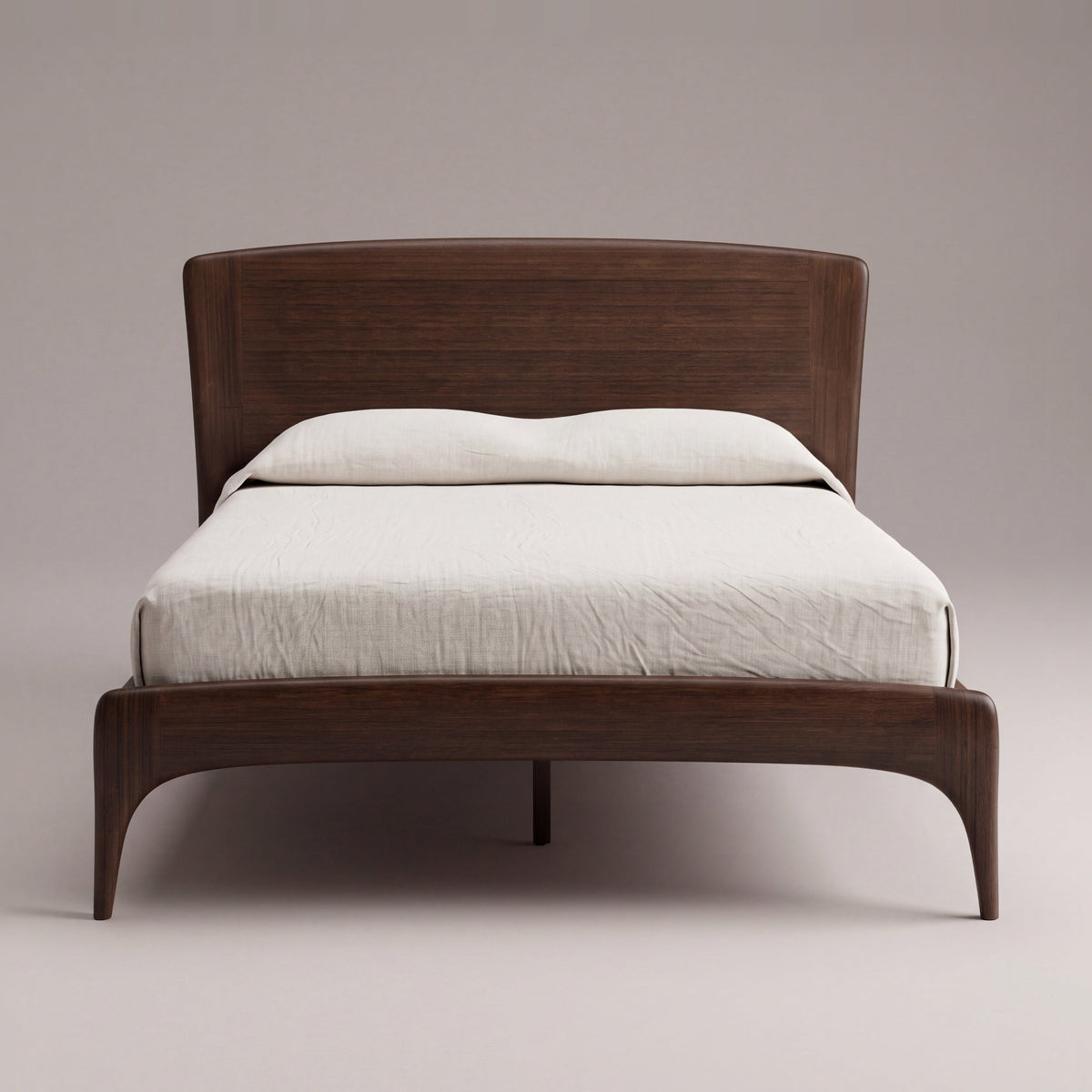 Greenington Zeva Platform Bed in Black Walnut bamboo with ivory linen bedding, on a light studio background, front view from the foot end