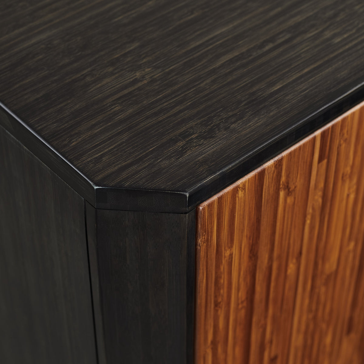 Close-up of the corner joinery on the Greenington Sonoma Sideboard/Media/Credenza in Amber and Caviar bamboo